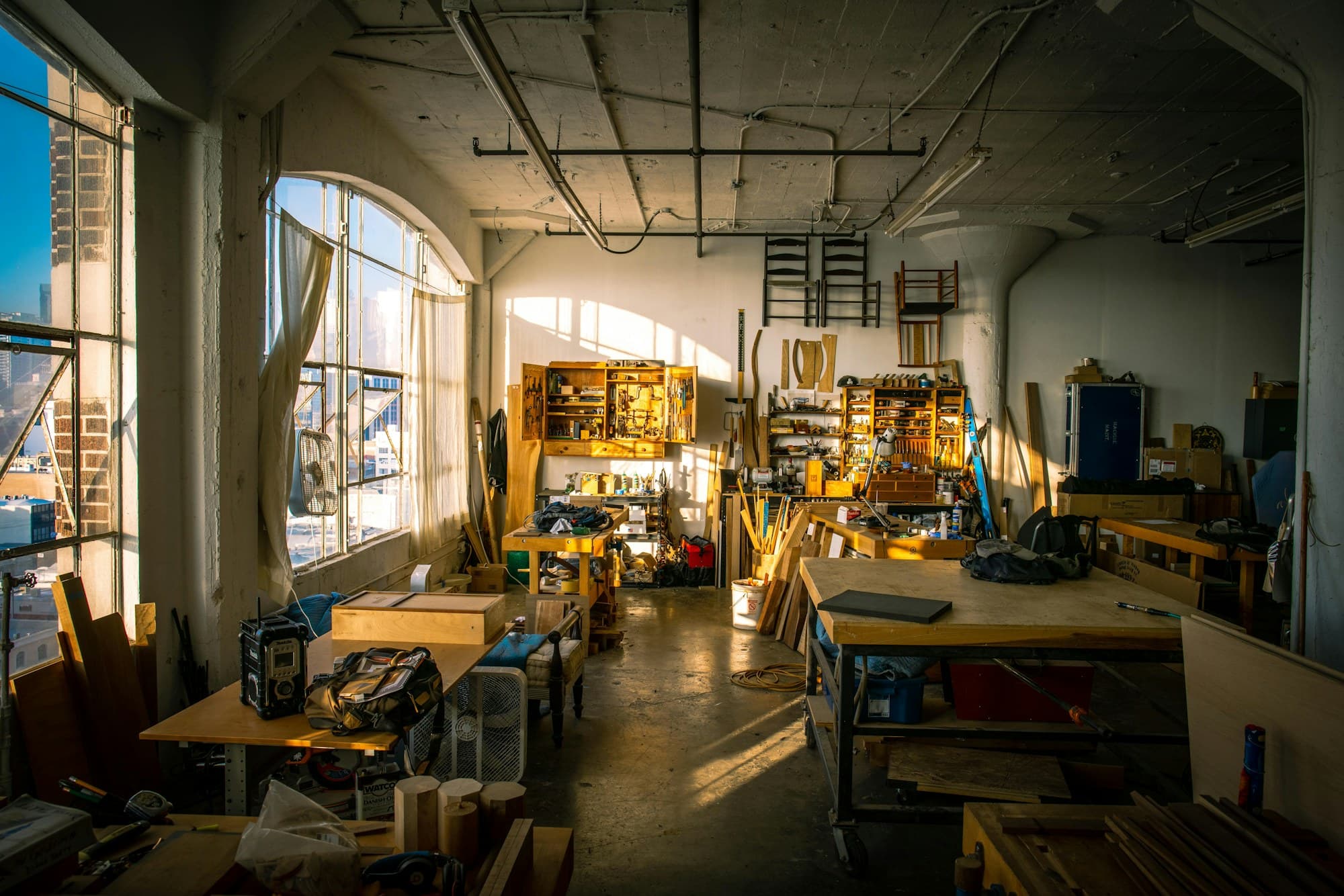 A traditional workbench with hand tools in warm light