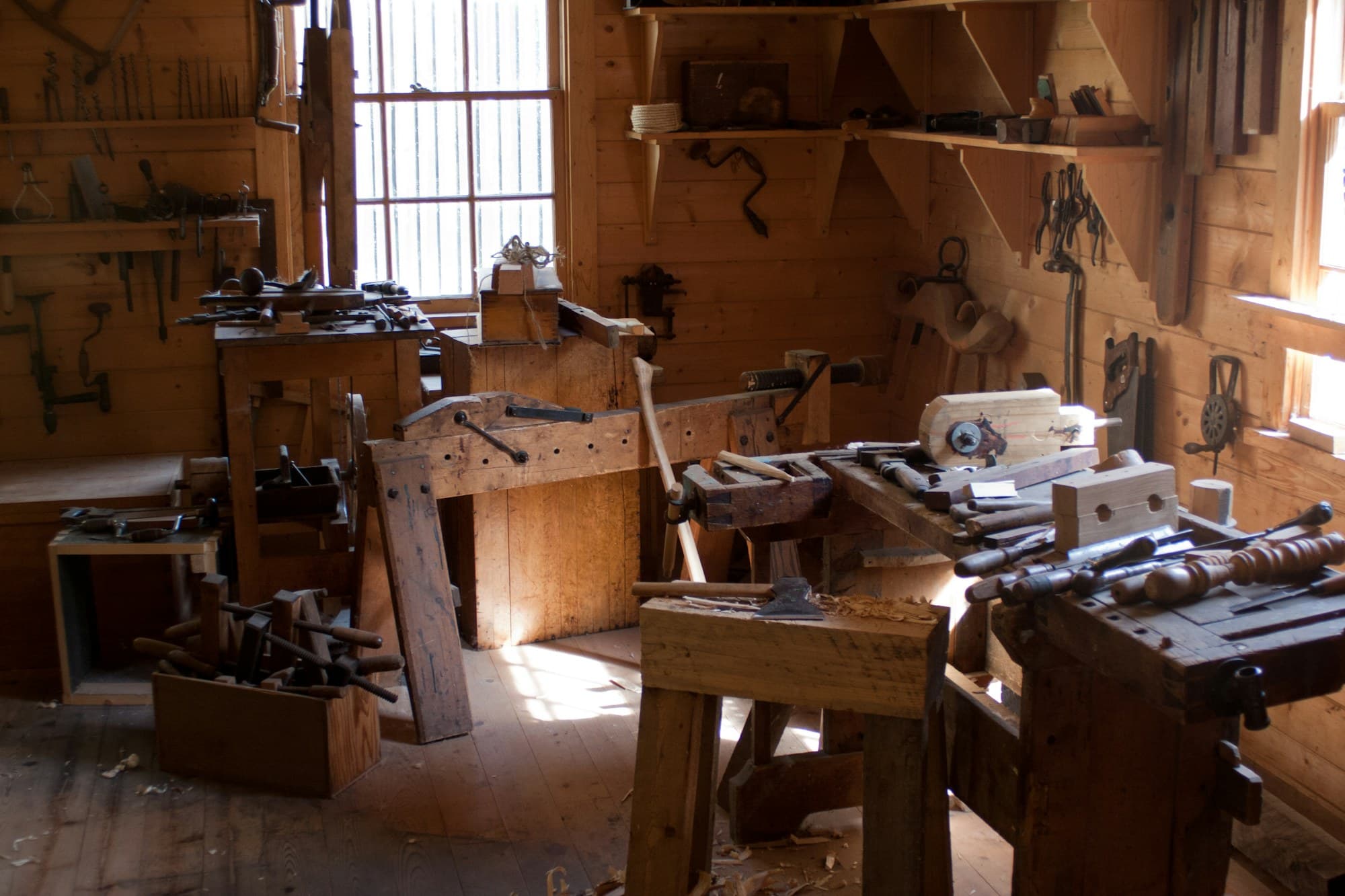 A lathe turning timber, shavings lifting away