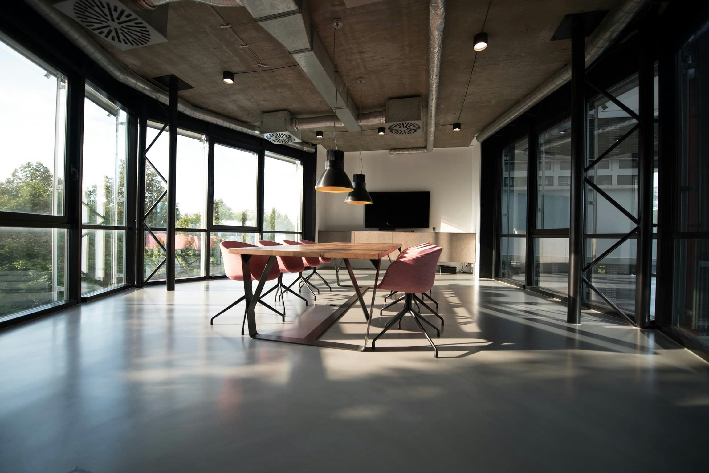 A boardroom table and seating in a daylit office