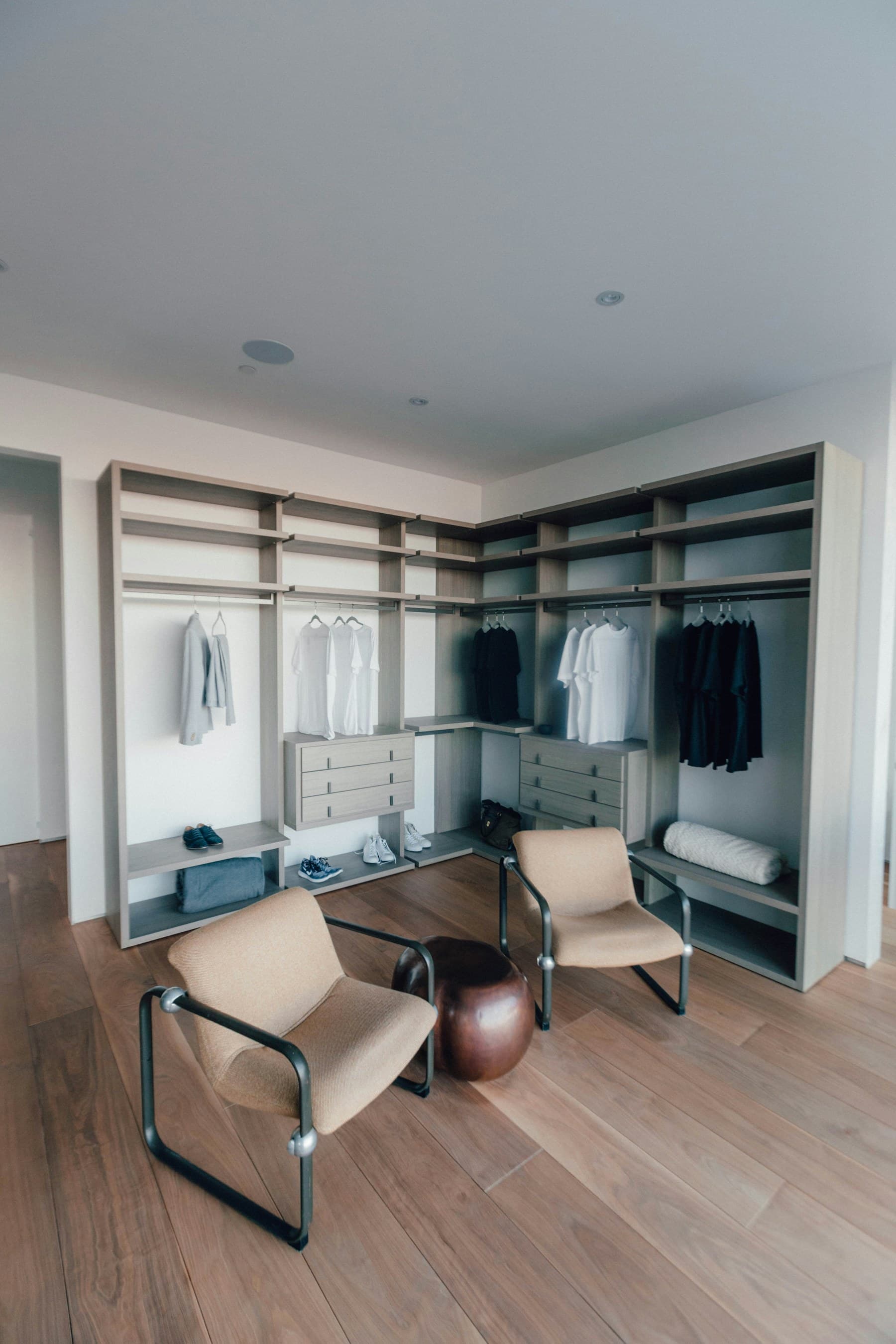 A fitted wardrobe with sliding doors and interior lighting